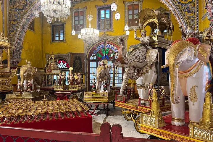 An interior displaying ornate elephant statues and golden artifacts.