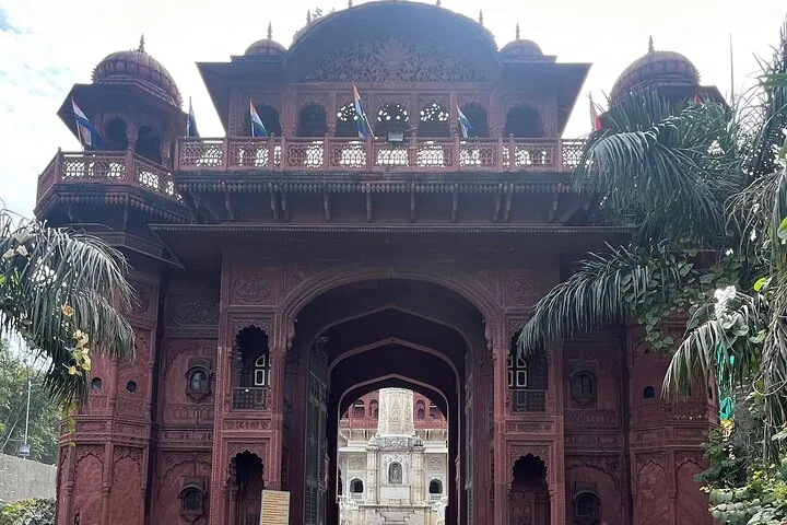A large, ornate red sandstone archway with intricate carvings.
