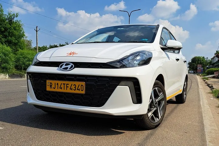 A white Hyundai car parked on the side of a road.